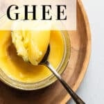 ghee in a jar on a wooden plate (pinterest image)