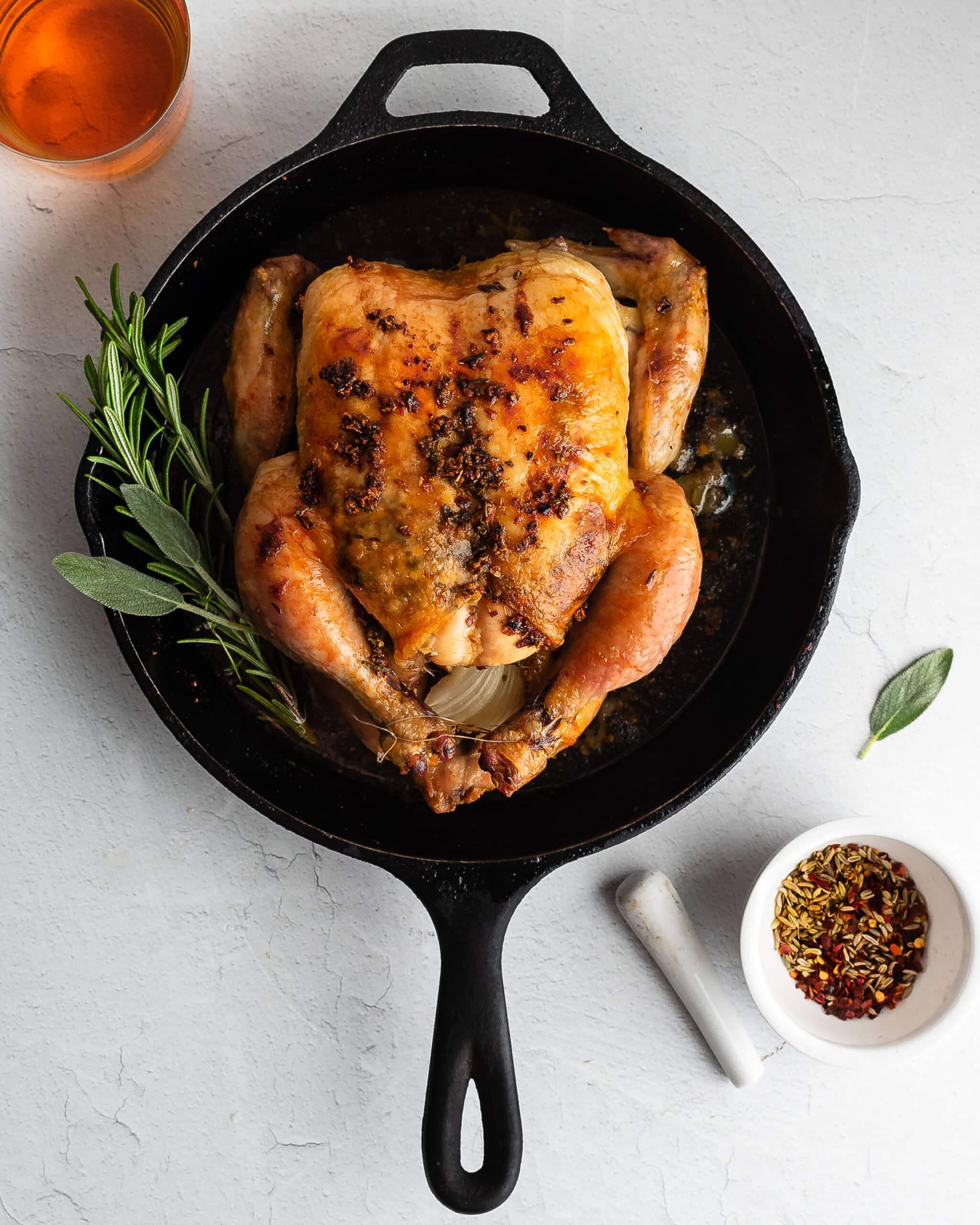 Slow-roasted chicken in a cast iron skillet.