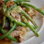 Green beans with chicken and gravy on plate