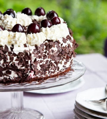 Sourdough black forest cake on cake stand on a table