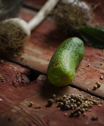 cucumber and garlic on wooden surface