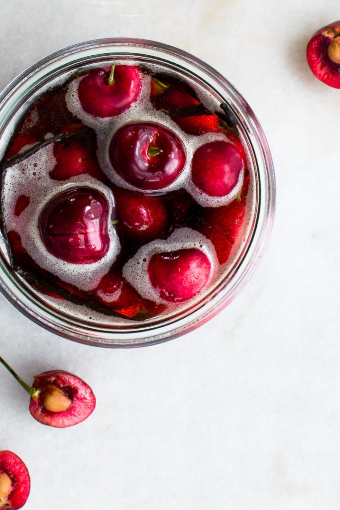 brandied cherries in a jar with vanilla bean