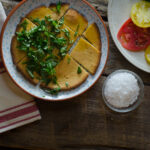 socca on white plate garnished with herbs