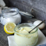 avocado oil mayonnaise in glass jar on wood surface
