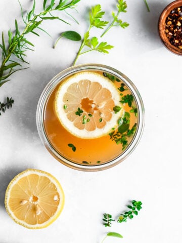 turkey bone broth garnished with herbs and lemon