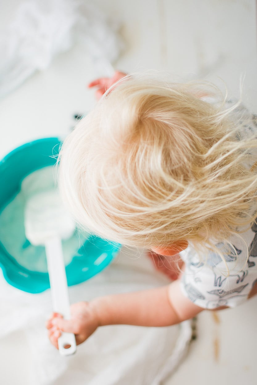 Baby mixing yogurt and honey.