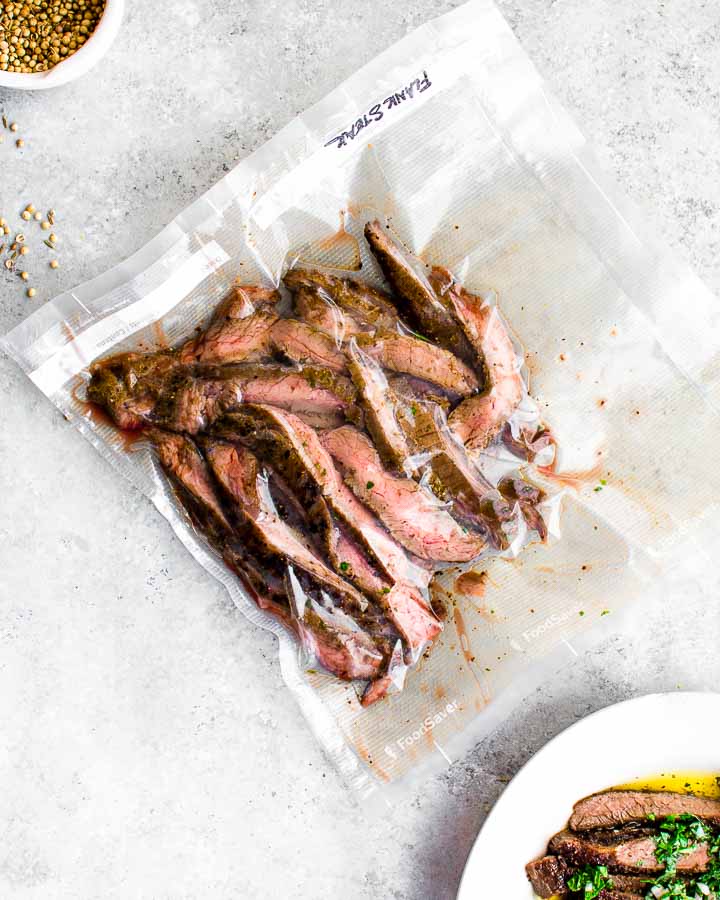 Leftover, sliced sous vide flank steak in a vacuum seal bag.