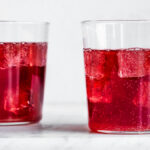 two cups of elderberry kombucha with ice