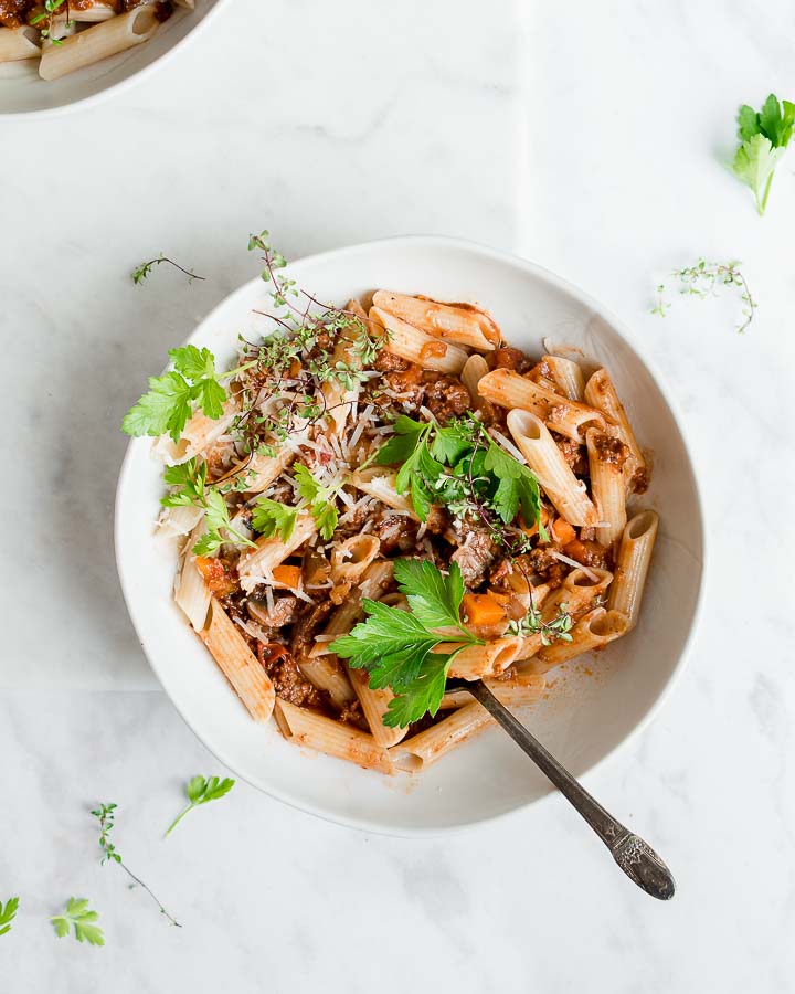 penne with meat sauce garnished with parmesean cheese and italian parsley