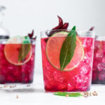 hibiscus elixer in a cup with ice and lime
