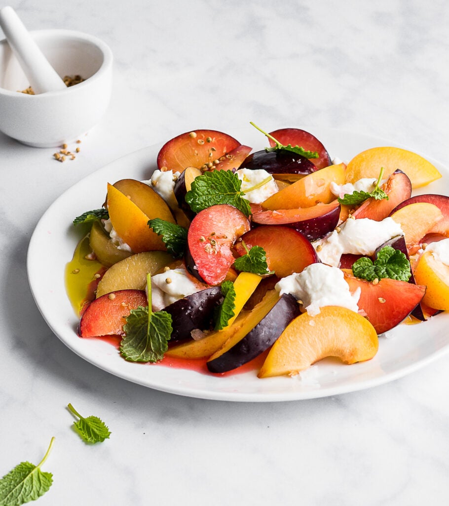 plum and mint fruit salad on yogurt