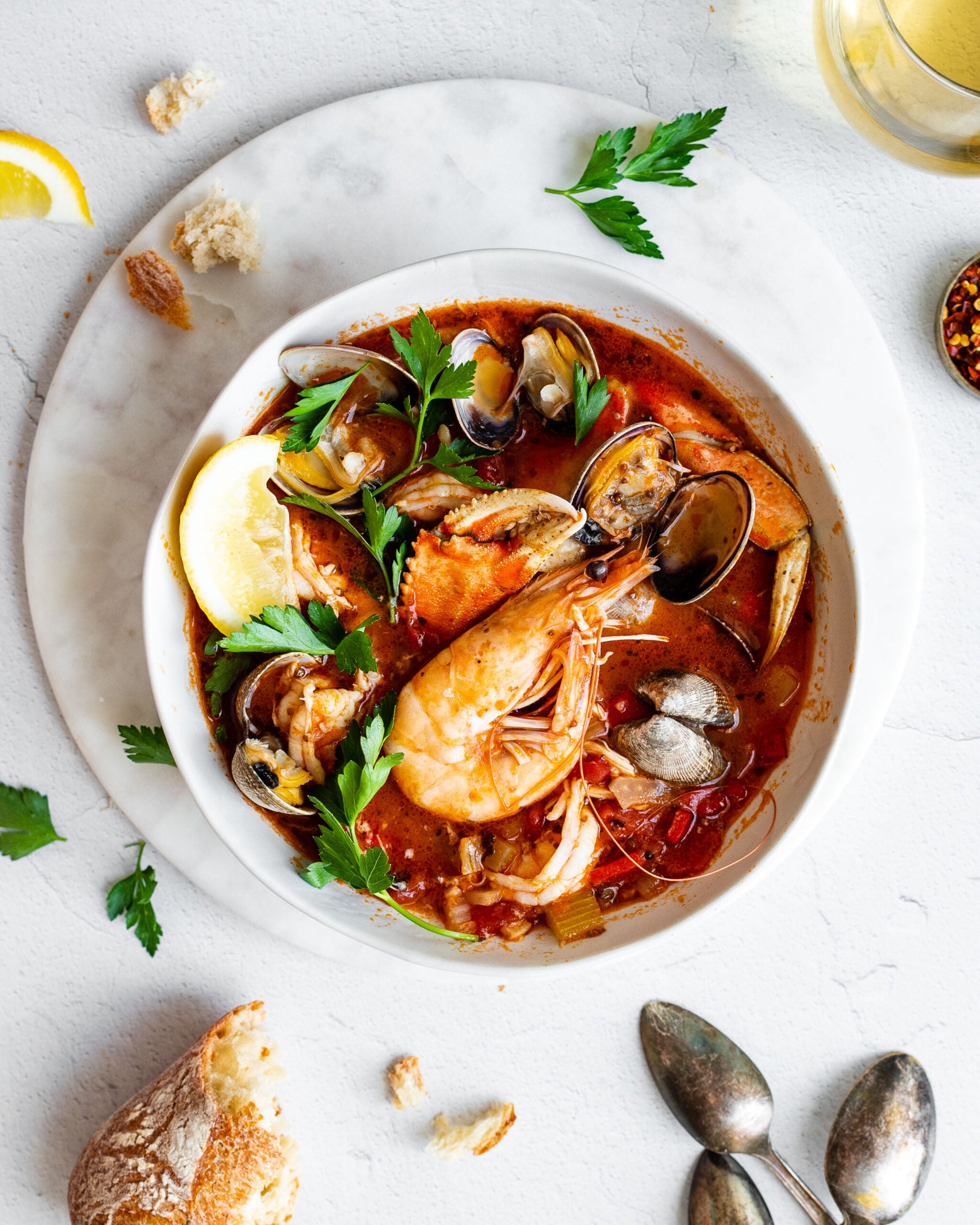 shellfish cioppino garnished with lemon and parsley