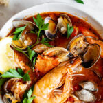 shellfish cioppino garnished with lemon and parsley