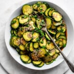 Asian Style Cucumber Salad garnished with garlic chives and sesame seeds