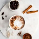chocolate tea latte in a white mug on a marble surface