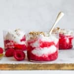 Cranachan in a small glass, garnished with fresh raspberries