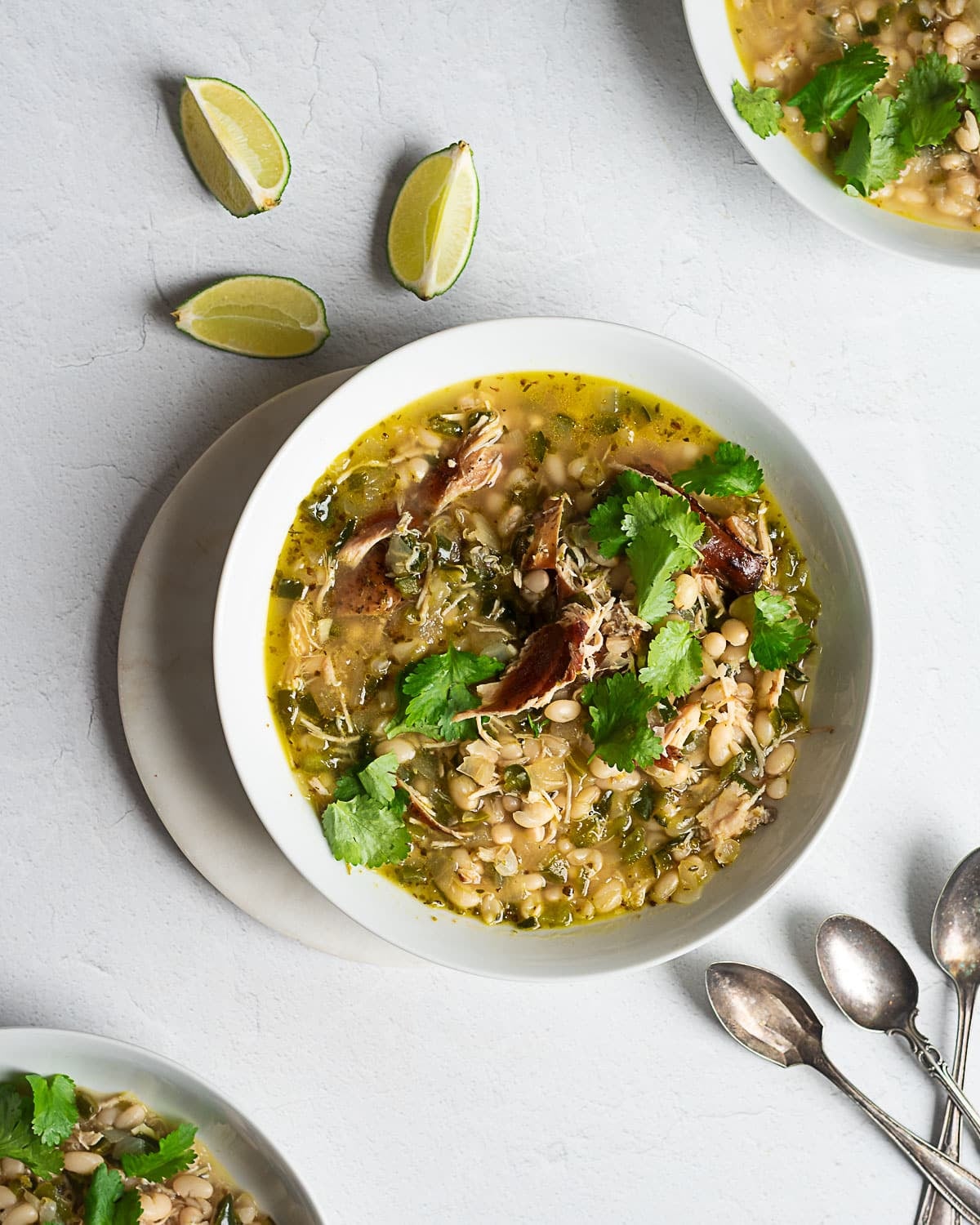 Green Chili Chicken garnished with cilantro in a white bowl