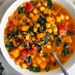 winter minstrone in a white bowl on a white surface